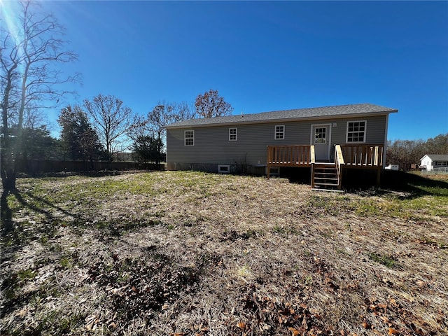 rear view of property with a wooden deck