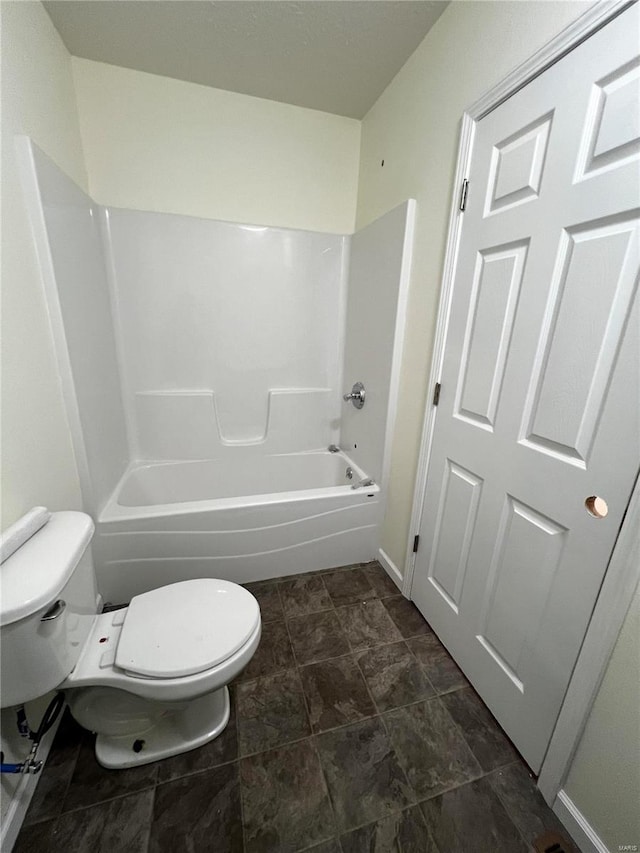 bathroom with bathing tub / shower combination and toilet