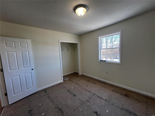 unfurnished bedroom featuring a closet and a textured ceiling