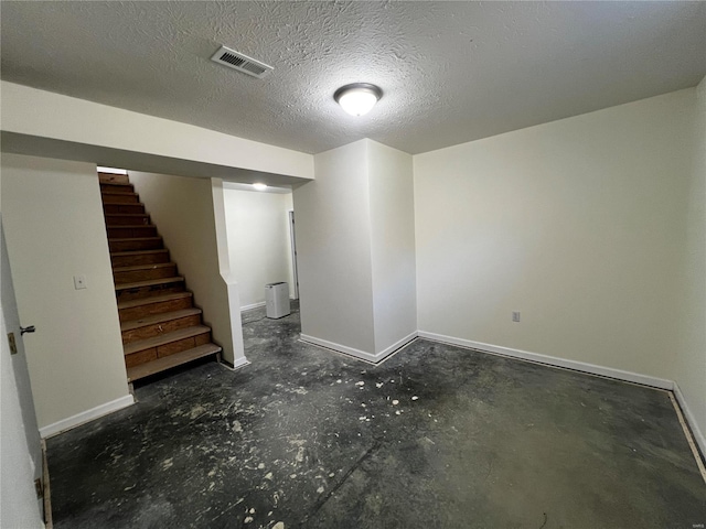 basement featuring a textured ceiling