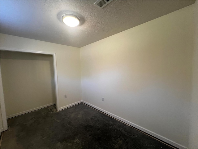 unfurnished bedroom featuring dark carpet and a textured ceiling