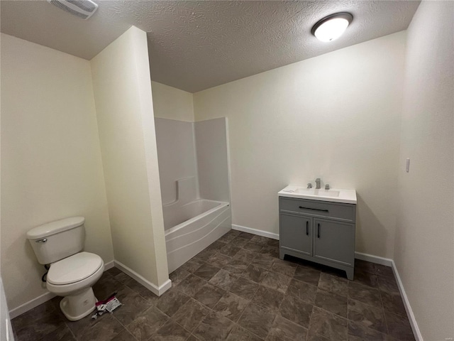 full bathroom featuring vanity, tub / shower combination, a textured ceiling, and toilet