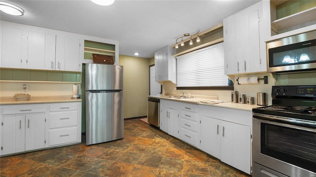 kitchen featuring white cabinets, sink, and appliances with stainless steel finishes