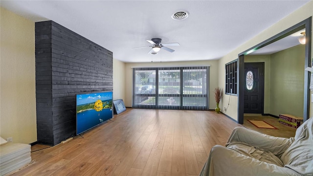 living room featuring ceiling fan and light hardwood / wood-style flooring