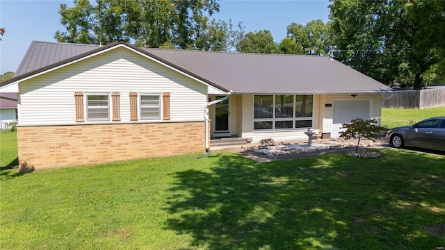 view of front of property featuring a garage and a front lawn