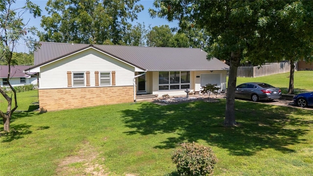 ranch-style home featuring a front lawn and a garage