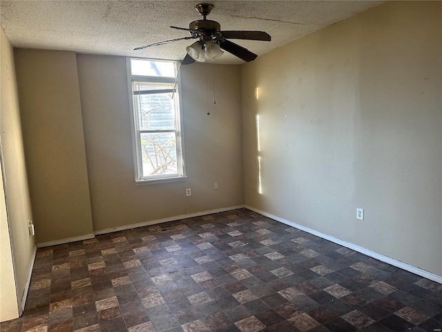 unfurnished room featuring a textured ceiling and ceiling fan