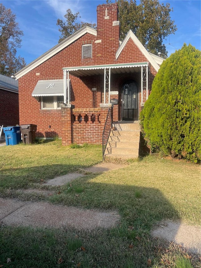 rear view of house with a lawn