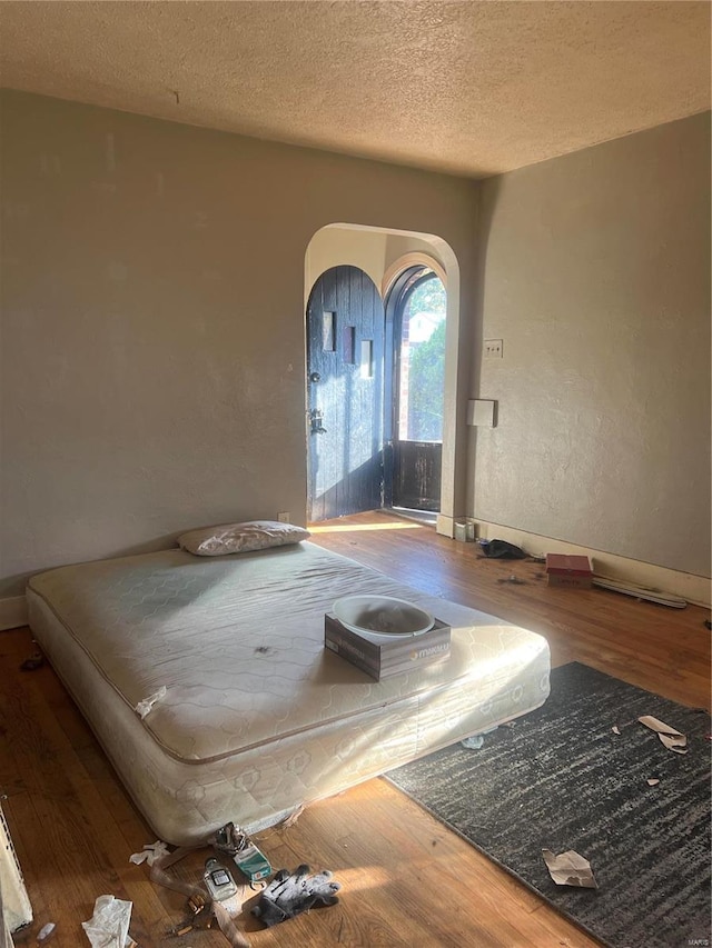 foyer with wood-type flooring and a textured ceiling