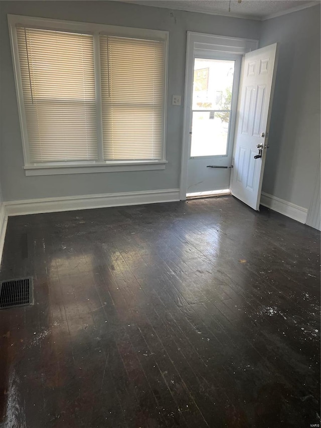 spare room featuring dark hardwood / wood-style flooring