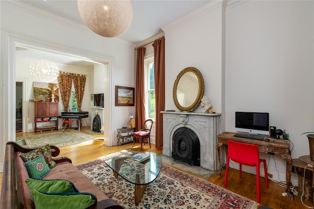 sitting room with ornamental molding and hardwood / wood-style flooring