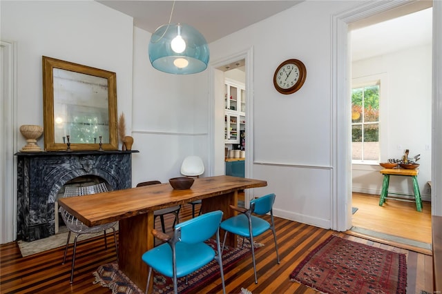 dining space featuring dark hardwood / wood-style floors and a fireplace