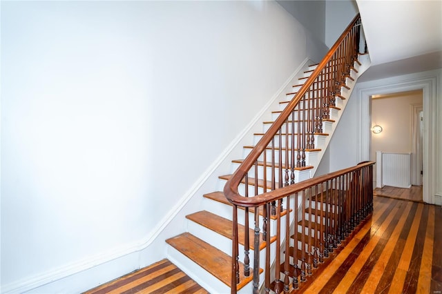 stairway featuring hardwood / wood-style flooring