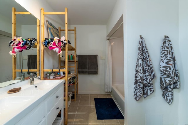 bathroom featuring tile patterned flooring, vanity, and shower / tub combo