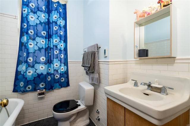 bathroom featuring a bath, tile patterned floors, toilet, and tile walls