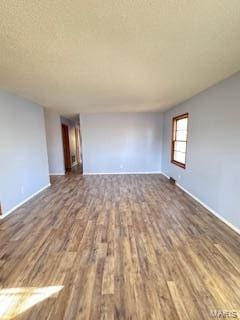 spare room featuring dark hardwood / wood-style flooring