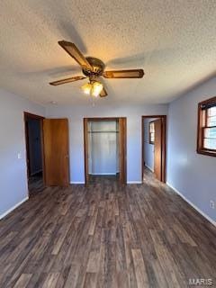 unfurnished bedroom with ceiling fan, a textured ceiling, and dark hardwood / wood-style floors