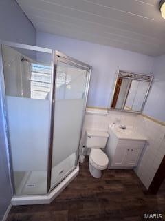 bathroom with walk in shower, vanity, toilet, and hardwood / wood-style floors