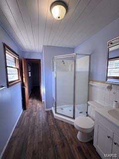 bathroom featuring a wealth of natural light, toilet, walk in shower, and hardwood / wood-style flooring