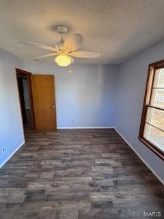 empty room with dark wood-type flooring, a textured ceiling, and ceiling fan