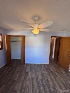 unfurnished bedroom with ceiling fan, a textured ceiling, a closet, and dark hardwood / wood-style flooring