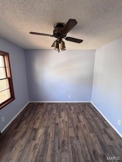 empty room featuring a textured ceiling and dark hardwood / wood-style floors