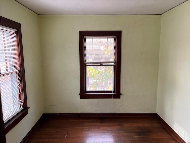 spare room with dark hardwood / wood-style flooring