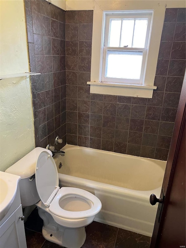 full bathroom with tile patterned flooring, vanity, toilet, and tiled shower / bath