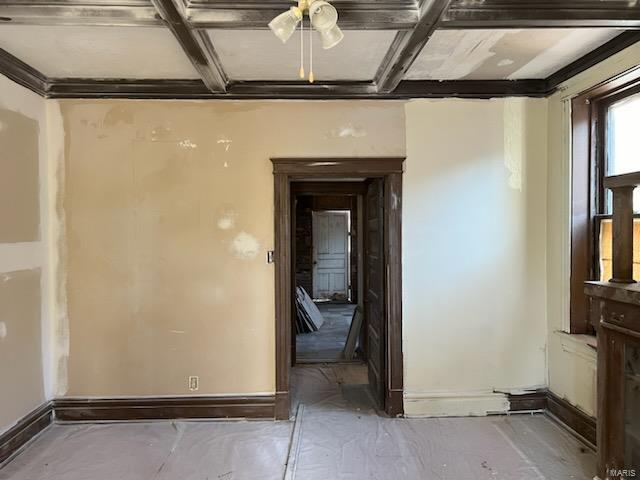 empty room with beamed ceiling and coffered ceiling