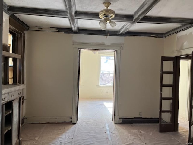 interior space featuring carpet flooring, ceiling fan, beam ceiling, and coffered ceiling