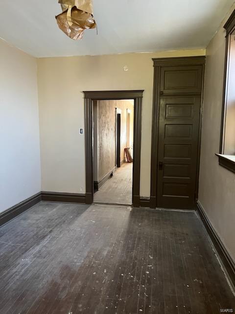 unfurnished room featuring dark wood-type flooring