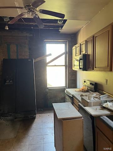 kitchen featuring black appliances, ceiling fan, and a kitchen island