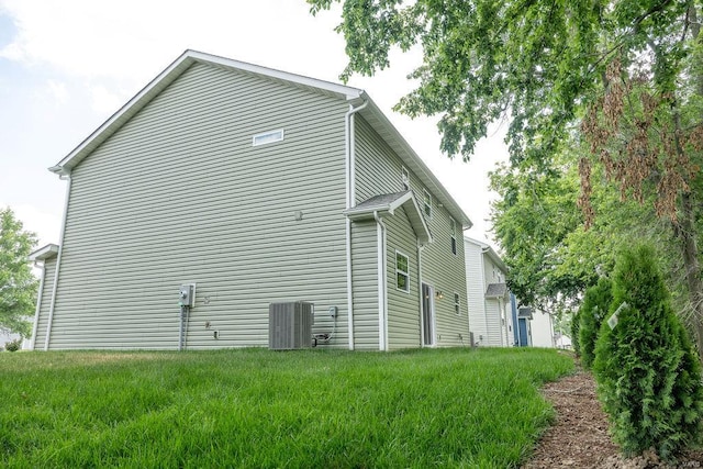 view of home's exterior featuring central AC and a yard