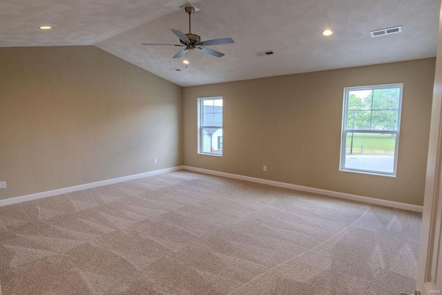 unfurnished room with lofted ceiling, light carpet, and ceiling fan