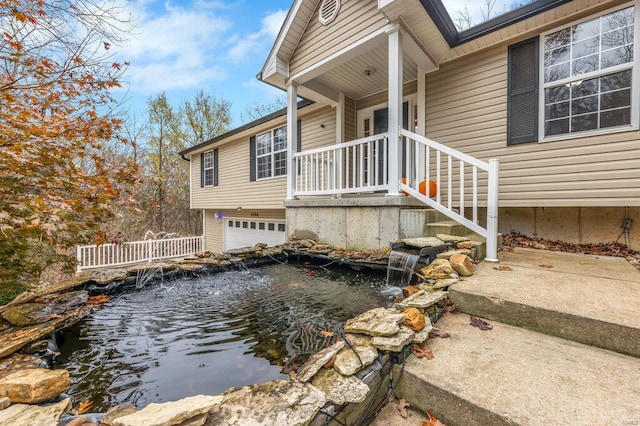 exterior space featuring a garden pond and a garage