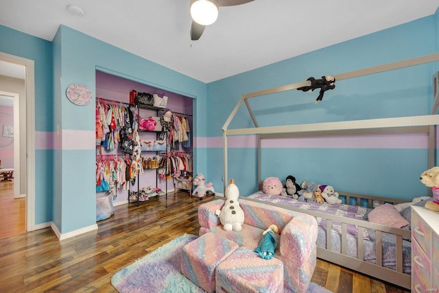 bedroom with a closet, ceiling fan, and dark hardwood / wood-style floors