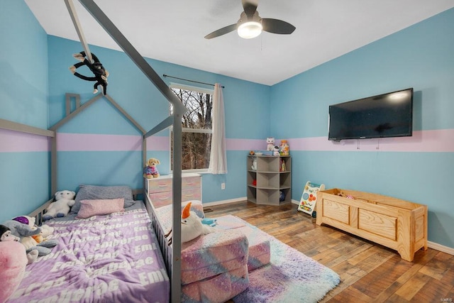 bedroom with ceiling fan and hardwood / wood-style flooring