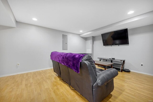 living room featuring electric panel and light wood-type flooring