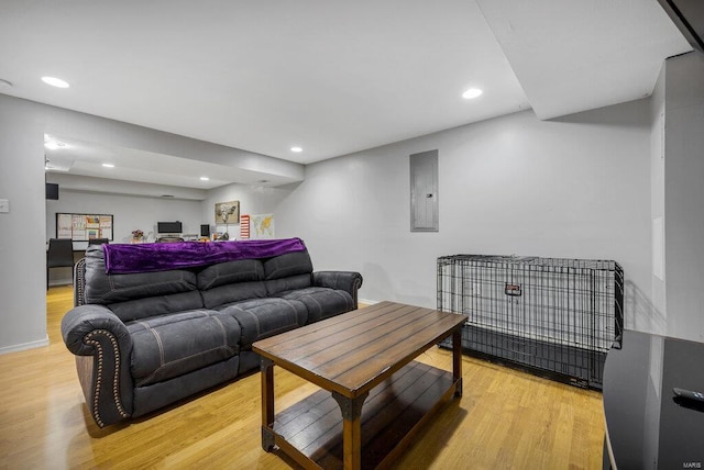 living room with light wood-type flooring and electric panel