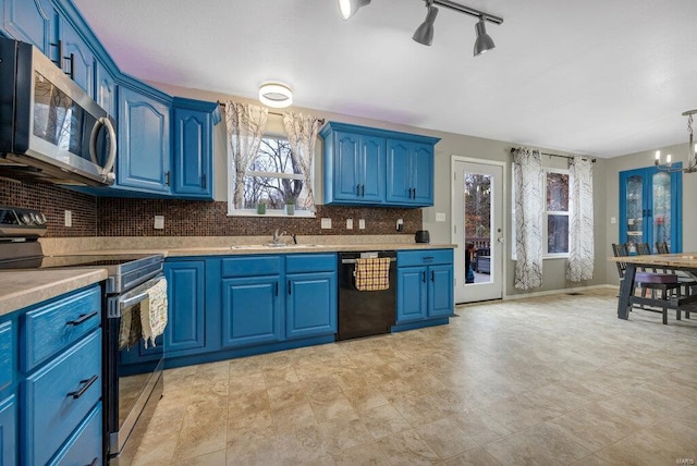 kitchen with blue cabinets, stainless steel appliances, and an inviting chandelier