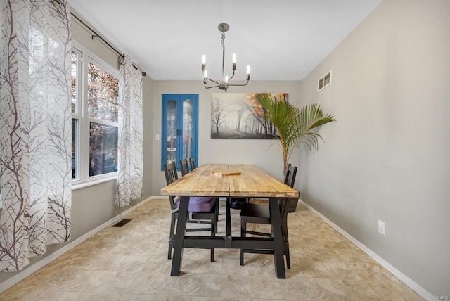 dining area with an inviting chandelier