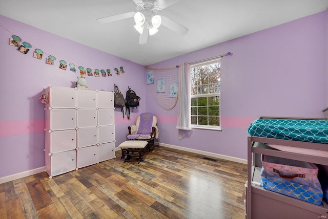 bedroom with ceiling fan and dark wood-type flooring