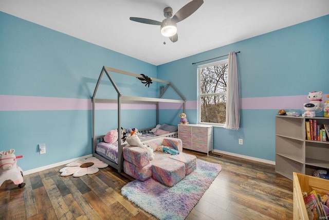 bedroom with ceiling fan and dark hardwood / wood-style floors