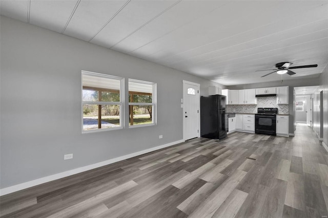 unfurnished living room featuring wood-type flooring and ceiling fan