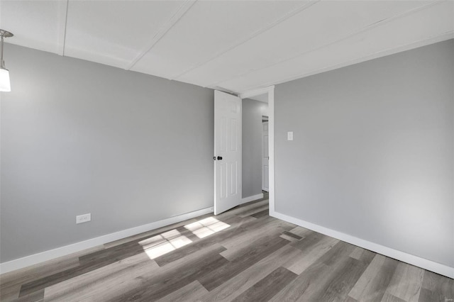 unfurnished room with hardwood / wood-style flooring