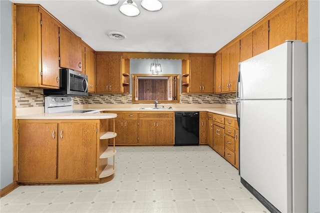 kitchen with dishwasher, sink, kitchen peninsula, stove, and white fridge