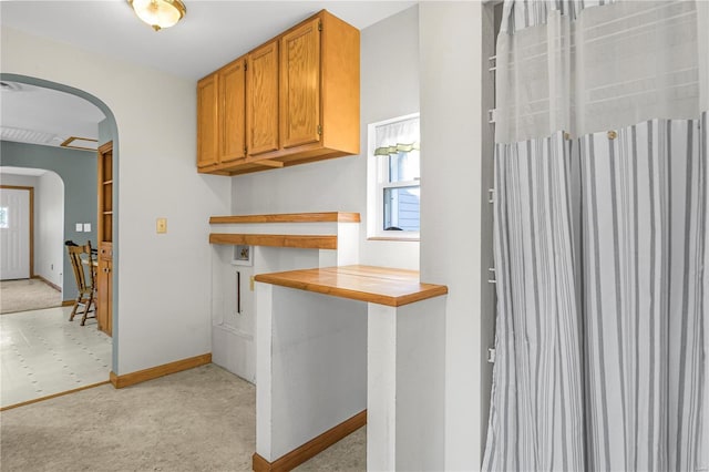 kitchen featuring tile countertops and light colored carpet