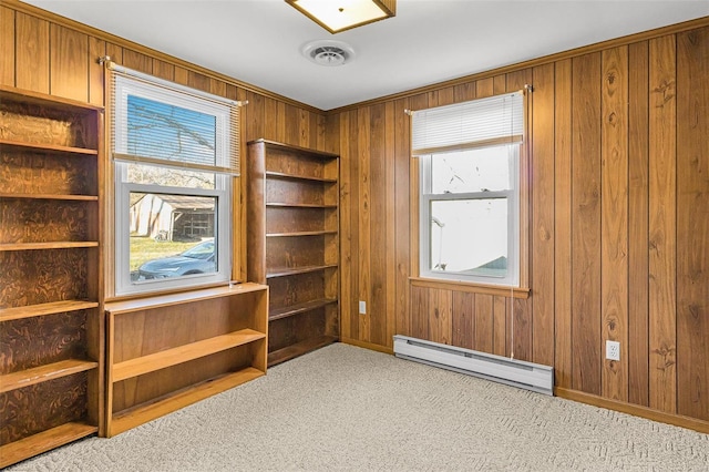 misc room with light colored carpet, baseboard heating, and wooden walls