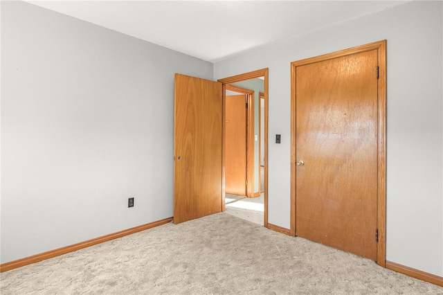 unfurnished bedroom featuring light carpet