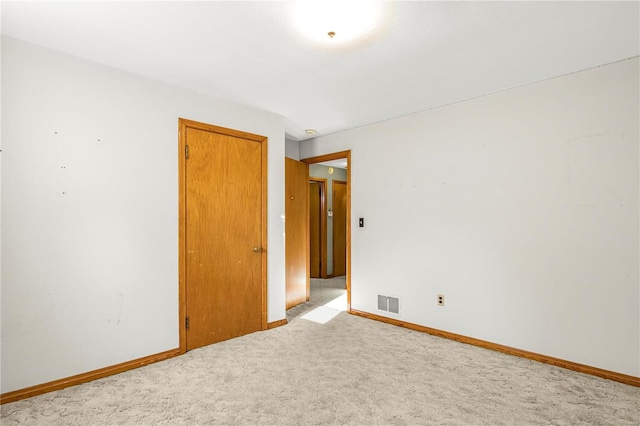 empty room with light colored carpet